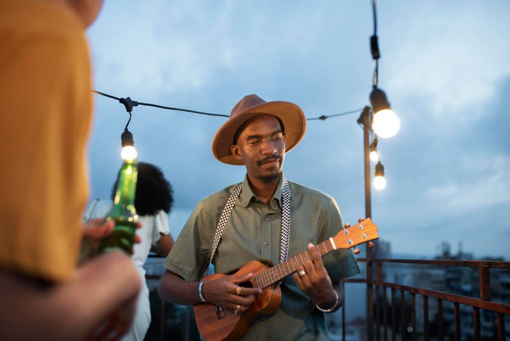 Man playing ukulele at party